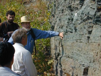 Don touches a rock face while three others look on