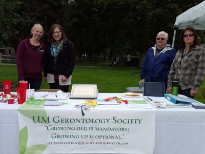UMGS table at Welcome Feast with banner