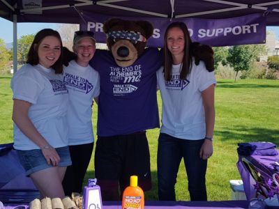 UMGS members and Monte the bear help at the merchandise table
