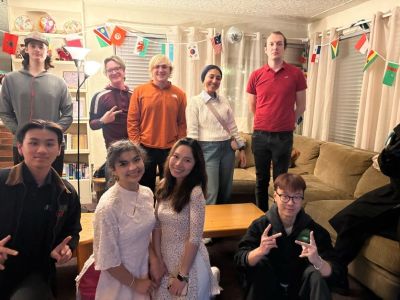 Group of people inside a house smiling for a photo