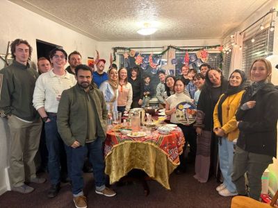 Group of students posing for a photo in a dining room