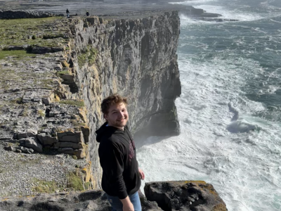Student standing on the cliffs of mor