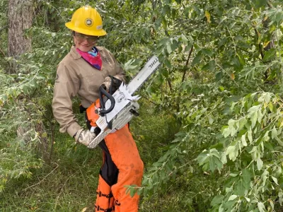 Student holding chainsaw