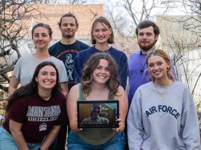 capstone group smiles for photo