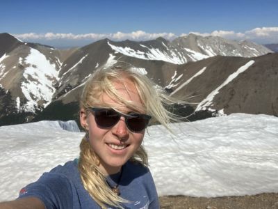 Girl smiles atop mountain in Argentina