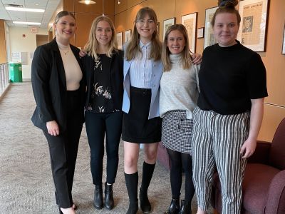 students stand in hallway