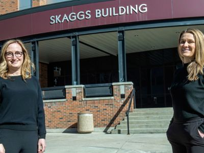 Erica Woodahl and Hayley Blackburn post out front of Skaggs Building at University of Montana