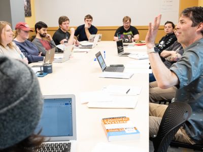 wiltse sits at a table with students