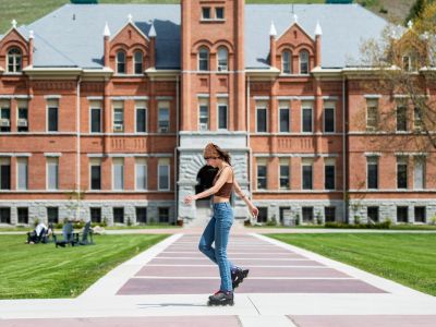 Girl roller skating on UM campus