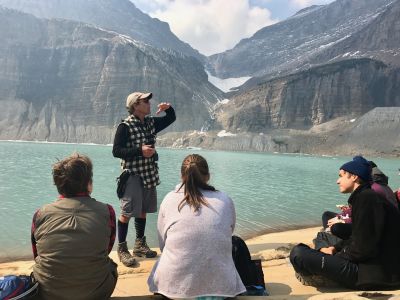 Photograph of teacher and students by lake in Glacier National Park