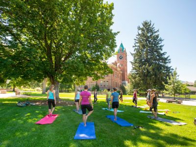 students doing yoga outdoors