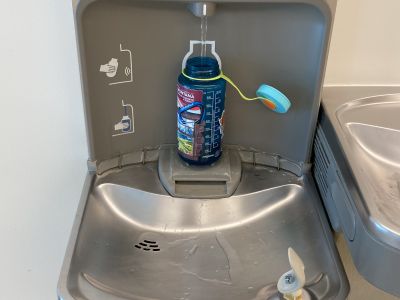 a water bottle being filled up at a station