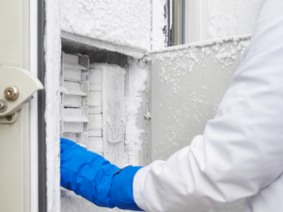 scientist opening the door of the ULT freezer