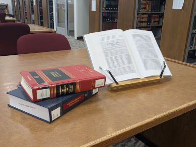 Law books opened on a table within the law library.