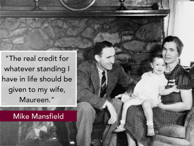 Mike and Maureen Mansfield holding a child in their home