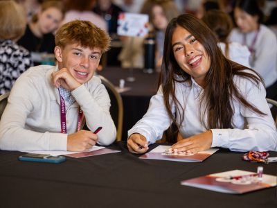 Two students smiling at the camera.