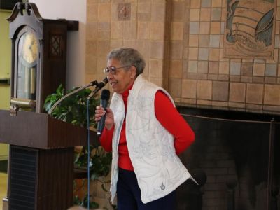 Dr. Hewitt speaks into a microphone