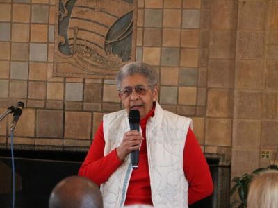 Dr. Hewitt speaks into a microphone
