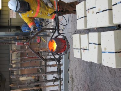 Patrick Eckman gets the crucible in place above a mold.