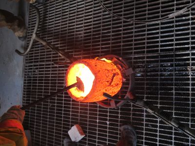 Brad Allen scrapes the edges of the crucible.