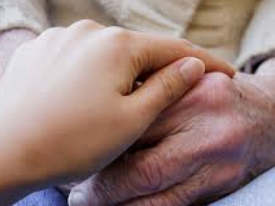 young hand on top of an older hand