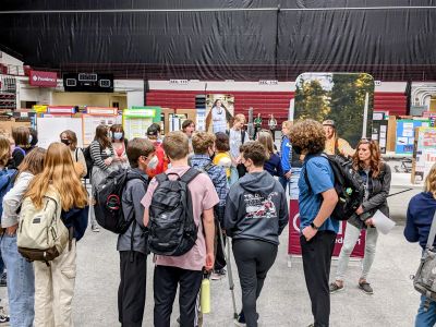Kids walking with Backpacks on the Fair Floor