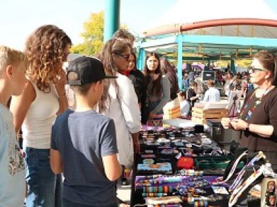 people buy beads from an indigenous seller at the Missoula market