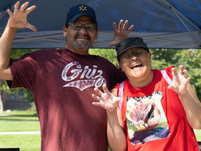Two Students at welcome feast showing their best Grizzly bear stance 
