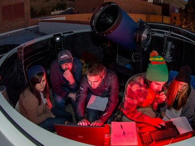 Students at telescope on the roof of Skaggs