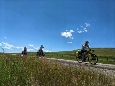 Student biking with gear on 