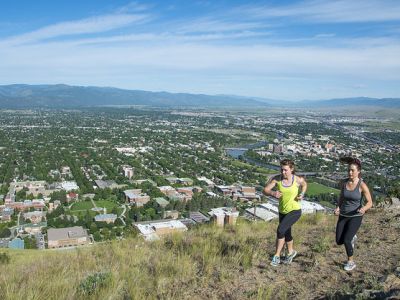 two women running on trail above missoula