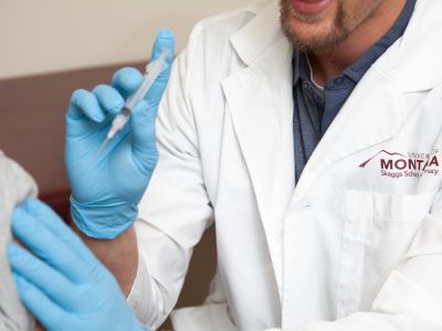 a syringe injection into an arm