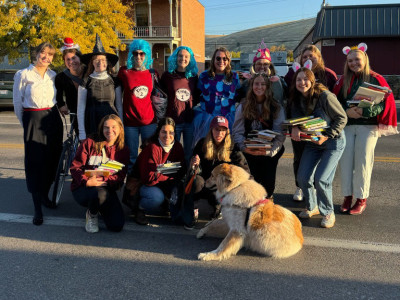 a group of costumed students and a sign for nsslha posing