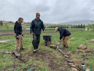 Volunteers making a pathway in the garden