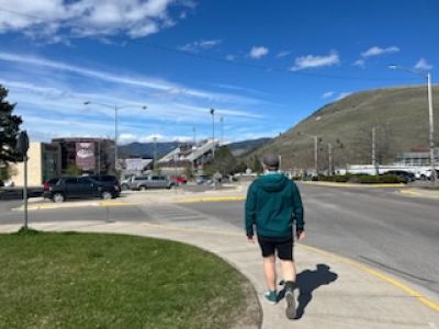 The author leads a soundwalk. Shot from behind. Mountains in background; industry in foreground.