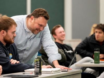 professor helping students in class