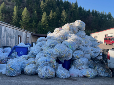large mountain of bags of recycling cans