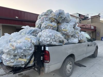 a truck overflowing with beer cans from the zero waste concert series