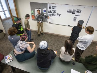 students sitting in circle listening to professor