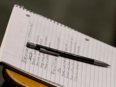 student taking notes in notebook