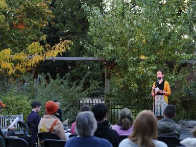 crowd watches as sustainability slam participant speaks into the microphone