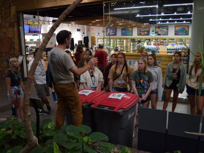 derek outside of the UC market teaching students about our all in the hall bins and glass recycling