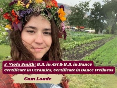J. Viola Smith looks into camera, wearing flower crown