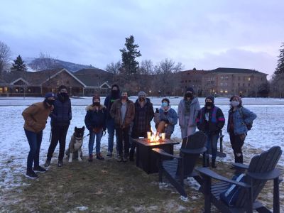 Studetns gathered around a fire pit to celebrate rainbow welcome