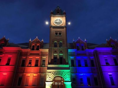 Main Hall lit up with pride flag colors