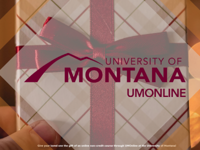 Holiday themed gift box with UM Online Logo in the center. 