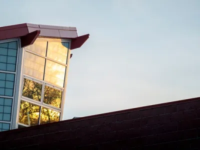 The sun reflects off the window of UM's Payne Family Native American Center