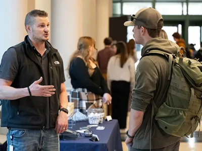An employer and a student talk at a job fair