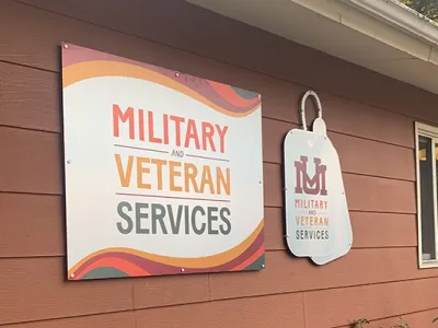 Two signs indicate UM's Military and Veteran Services Office