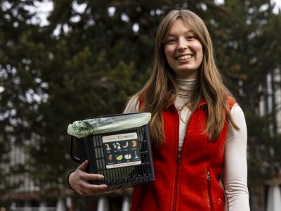 Student holding a recycling device 